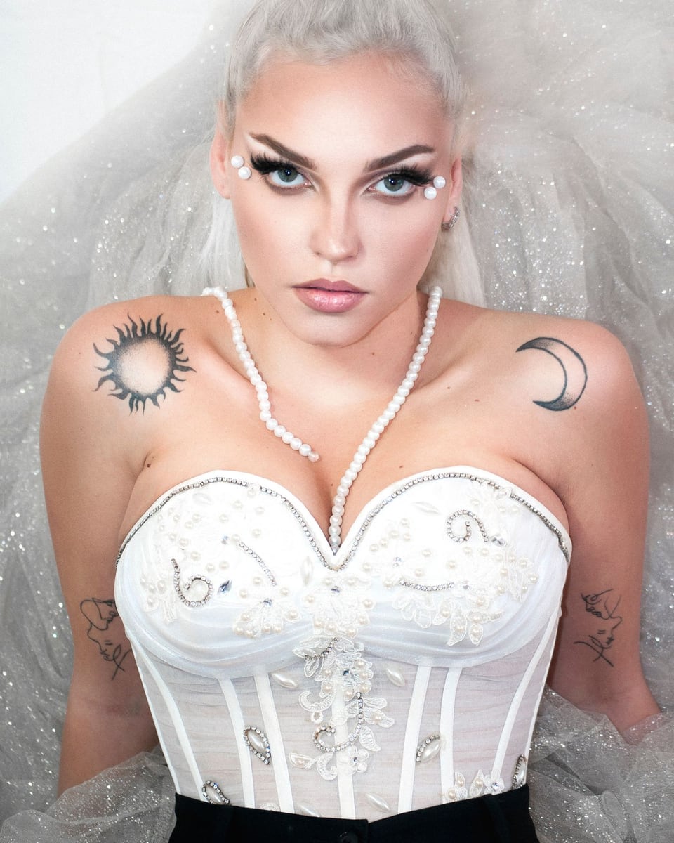 Illustrative close-up photograph of a silver-haired bride wearing a detailed lace wedding dress.